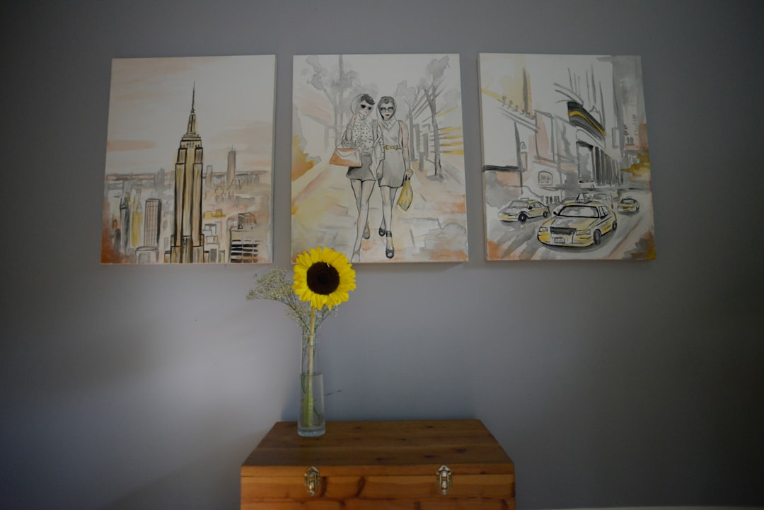 A happy young couple works together painting a wall in their new home, symbolizing the collaborative effort of a fixer-upper project.