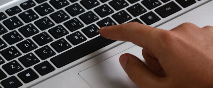 How Algorithms Decide Which Real Estate Agents Win Online Close-up of a human hand touching a glowing, futuristic digital screen displaying a network of profiles, symbolizing an al...