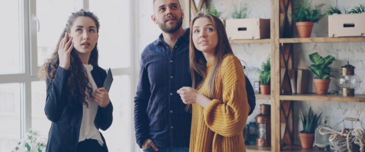 Real Estate Team vs. Solo Agent: Who to Hire When Selling in Kennewick, WA Diverse team of professional real estate agents working together and collaborating around a table in a bright, modern office.